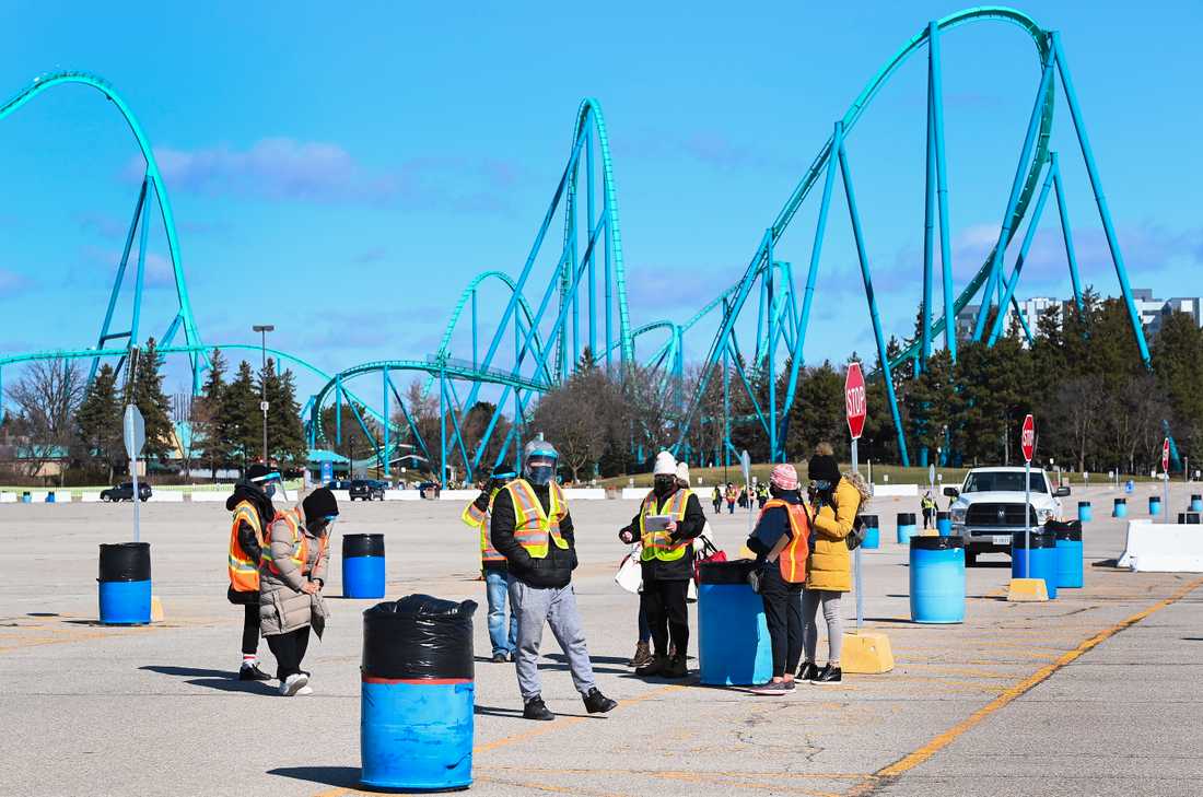     Wonderland theme park in Vaughan, Ontario, has been transformed into a comprehensive vaccination site where healthcare professionals receive patients outdoors.