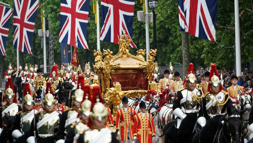 The 260-year-old gold carriage that took Elizabeth II to her coronation in 1953 rolled through the streets of London on Sunday.  But there is no queen in it, just a hologram.
