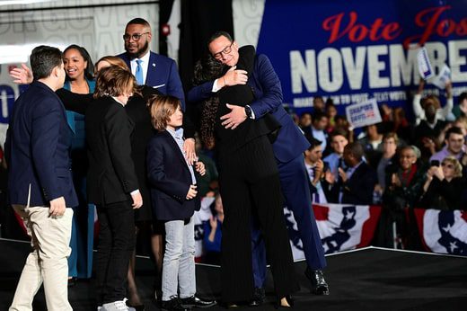 Democrat Josh Shapiro embraces his family after it turns out he's defeated Republican Doug Mastriano in the Pennsylvania governor's race.
